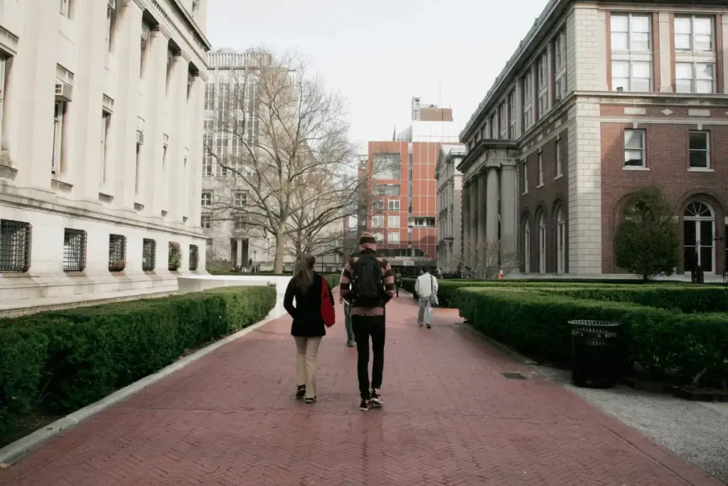 A young couple in therapy walking on a college campus.