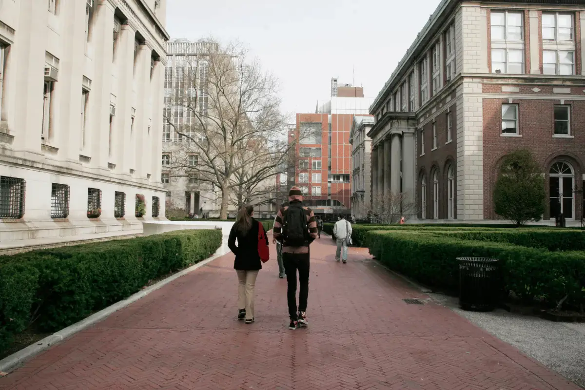 A young couple in therapy walking on a college campus.