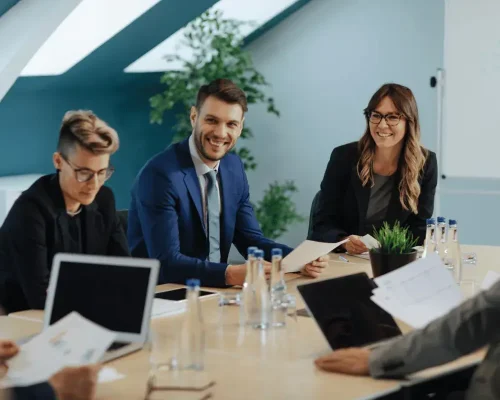 Several business people enjoying a board room meeting after therapy for professionals by Compass Psychological Services in Tampa, Florida.